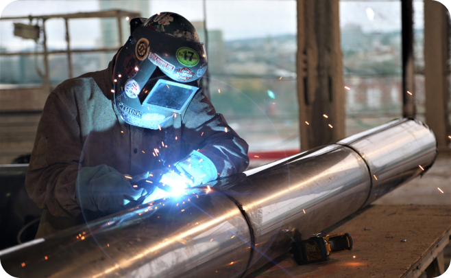 welder welding a metal tube