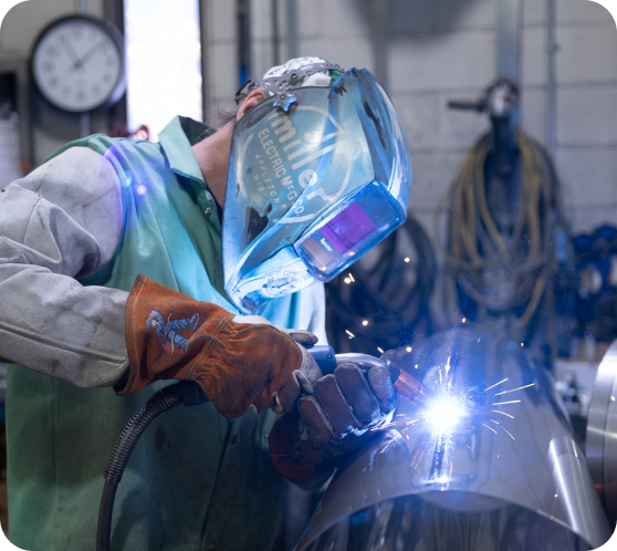 employee welding tube ductwork